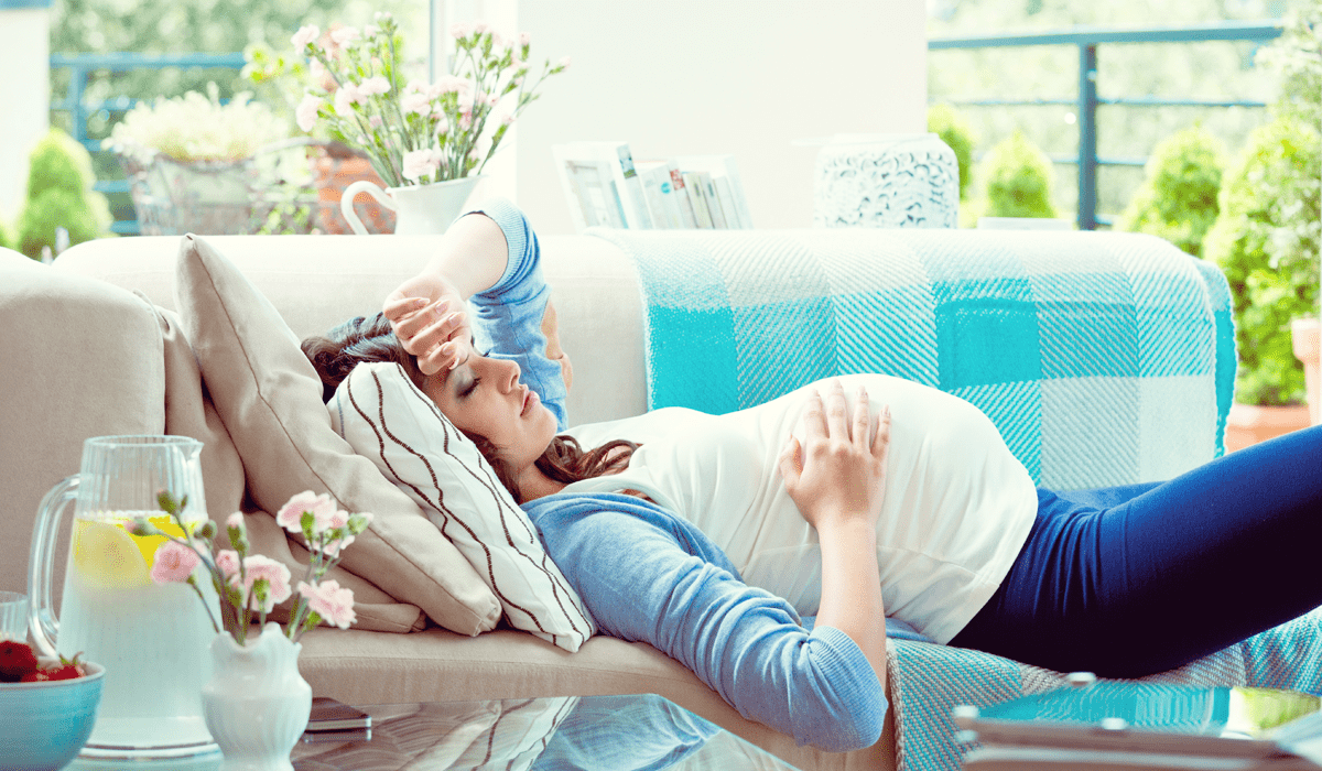 Verstopfung Schwangerschaft Schwangere Frau liegt auf der Couch